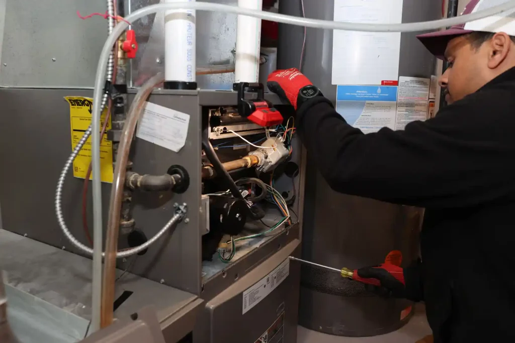Unionville Heating technician performing furnace repair and diagnostics on residential heating system
