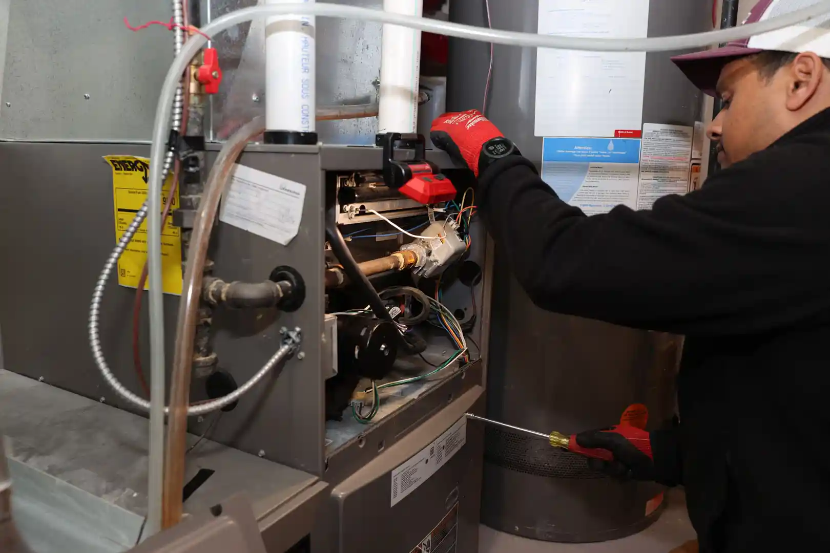 Unionville Heating technician performing furnace repair and diagnostics on residential heating system