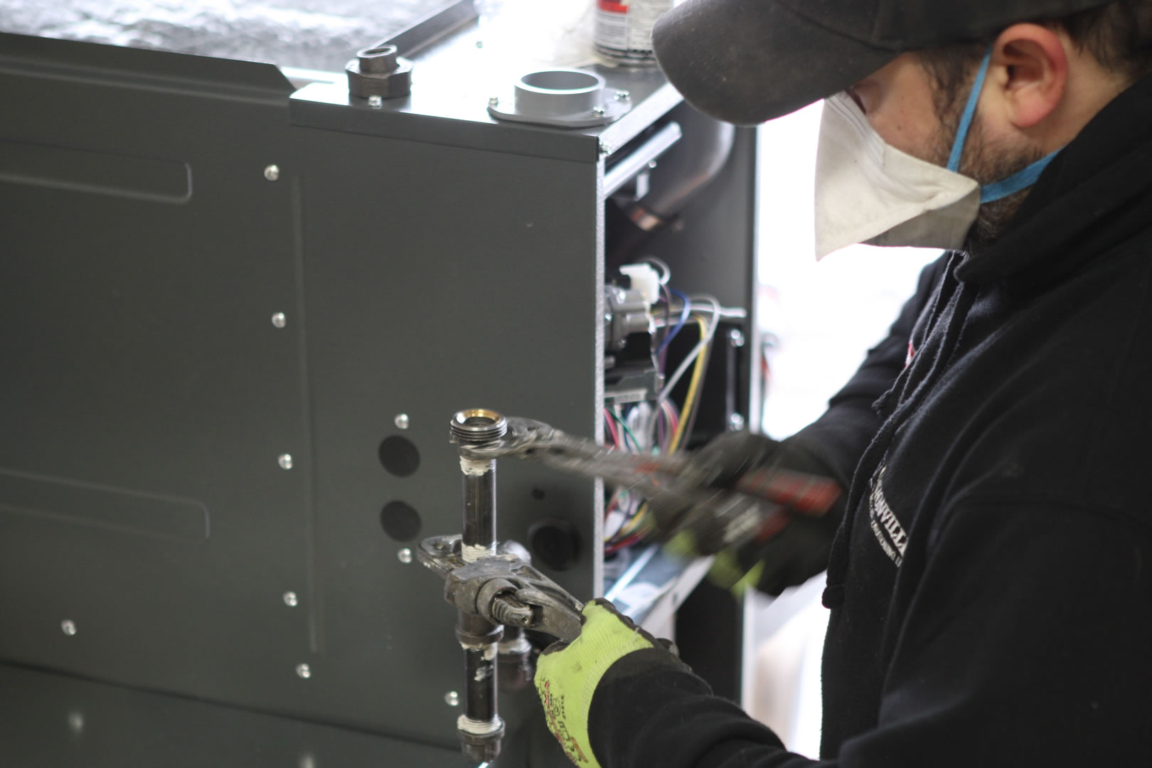 2. Garage Furnace Installation – The technician attaches the gas fittings.